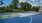 a tennis court with trees in the background