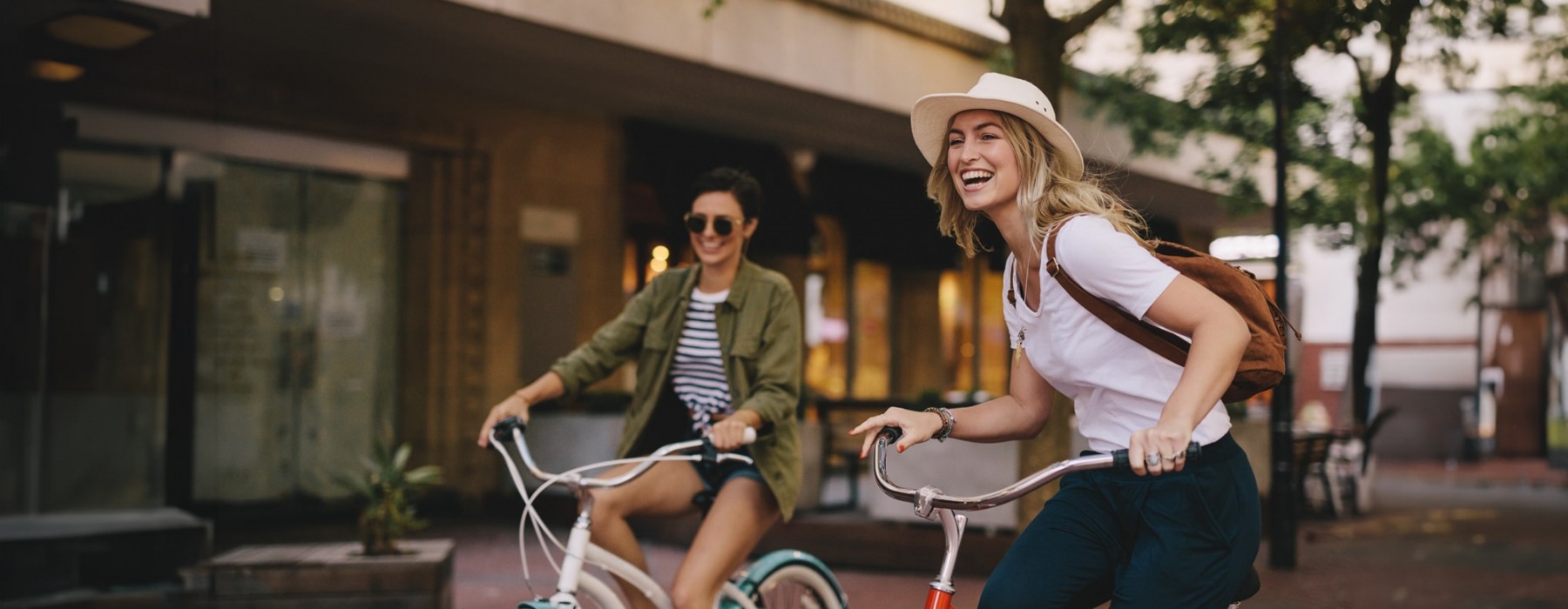 two women on bicycles outdoors